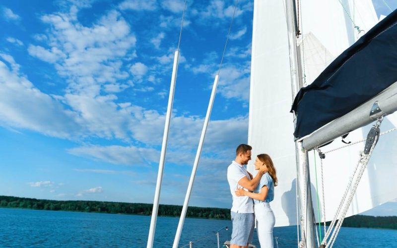 couple-on-yacht-hugging-sailing-at-seaside-enjoying-vacation-vertical-1.jpg